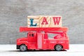 Toy Fire Ladder Truck Hold Block In Word Law On Wood Background
