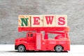 Toy Fire Ladder Truck Hold Block In Word News On Wood Background