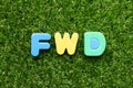 Toy letter in word FWD Abbreviation of forward on green grass background