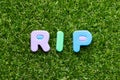 Toy letter in word RIP abbreviation of rest in peace on green grass background Royalty Free Stock Photo