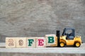 Toy forklift hold block B to word 29feb on wood background Concept for calendar date 29 in month February, leap day Royalty Free Stock Photo