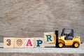 Toy forklift hold block R to word 30apr on wood background Concept for calendar date 30 in month april