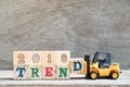 Toy forklift hold letter block d to complete word 2018 trend on wood background Royalty Free Stock Photo