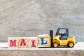 Toy forklift hold block l to complete word mail on wood background
