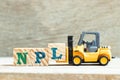 Toy forklift hold block l to complete word NPL Abbbreviation of Non Performing Loan, Non-Patent Literature on wood