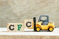 Toy forklift hold block to complete word Alphabet letter in word CFC abbreviation of Chlorofluorocarbon on wood Royalty Free Stock Photo