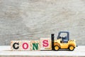 Toy forklift hold block s to complete word cons on wood background Royalty Free Stock Photo