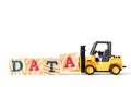 Toy forklift hold wood block A in word data on white background Royalty Free Stock Photo