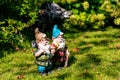 Toy garden gnomes on a sunny green lawn. Selective focus