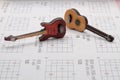 a toy guitar miniature on a music sheet Royalty Free Stock Photo