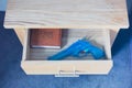 Toy gun and bible in drawer Royalty Free Stock Photo