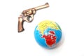 Toy gun on globe on white background Royalty Free Stock Photo