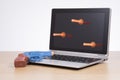 Toy gun and suction darts on laptop screen Royalty Free Stock Photo