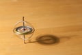 Gyroscope spinning and balancing on a wooden table