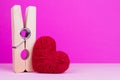 Toy heart and clothespin on pink background Royalty Free Stock Photo