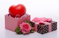 Toy heart in an open pink cardboard box with a bow of pink ribbon and jewelry in the form of a rose, a gift to the girl Royalty Free Stock Photo