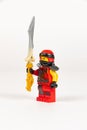 Toy hero Kai in a red kimono with a sword from a set of lego ninjago on a white background Royalty Free Stock Photo