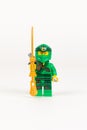 Toy hero Lloyd in a green kimono with a sword from a set of Lego ninjago on a white background Royalty Free Stock Photo