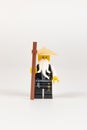 Toy hero Master Wu in a black kimono with a staff from a set of Lego ninjago on a white background. close-up