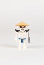 Toy hero skeleton Wyplash in a straw hat with a sword from a set of lego ninjago on a white background. close-up