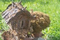 A toy homemade house of a fairy-tale creature made of logs and branches in the park