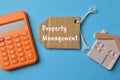 Toy house, calculator and label tag written with PROPERTY MANAGEMENT Royalty Free Stock Photo