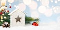 Toy house with christmas decoration in snowdrift Royalty Free Stock Photo