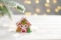 Toy house and christmas tree with fir cones, abstract light white natural holiday background with copy space Royalty Free Stock Photo