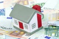 Toy house for euro banknotes as a background Royalty Free Stock Photo