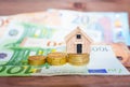 Toy house and euro banknotes with coins Royalty Free Stock Photo