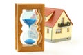 Toy house and hourglass with blue sand Royalty Free Stock Photo