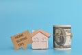 Toy house, money banknote and speech bubble note written with HOME BUYING TIPS Royalty Free Stock Photo