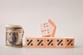 Toy house, money and percentage symbols. Low demand for home and the fall of the real estate market concept Royalty Free Stock Photo