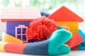 Toy house on the window sill wrapped in a scarf. Warming up the house. Royalty Free Stock Photo