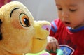 Toy lion with young boy