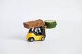 A toy loader or construction crane in bright yellow carries a piece of cucumber and a piece of black freshly baked bread. Close-up Royalty Free Stock Photo