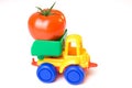 Toy lorry carrying a tomato Royalty Free Stock Photo