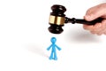 . Toy man and judge gavel isolated on white background. The concept of unfair judgments. Antipopular court. injustice