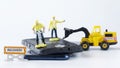 Toy man workers repair a mobile phone or smartphone using a jackhammer and a forklift truck. Concept for repairing, launching