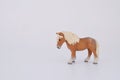 Toy miniature poney, isolated plastic toy poney on white background space for text