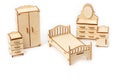 Toy miniature wooden bedroom furniture stands. Bed, wardrobe, bedside table and chest of drawers Royalty Free Stock Photo