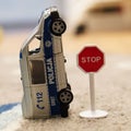 Toy model Polish police van laying upside next to a Stop sign. Royalty Free Stock Photo