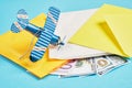 Toy model of a vintage plane, money, several parcels and several banknotes on a blue background, air mail concept, tracking Royalty Free Stock Photo