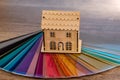 Toy model of wooden house on colour swatch