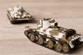 Toy models of Soviet tanks on a wooden table