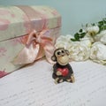 Toy monkey with red heart, white roses, vintage jewelry box and letter