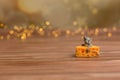 A toy mouse sits in cheese on a wooden starry background, a symbol of 2020. Royalty Free Stock Photo