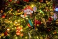 toy nutcracker on fir branch with lights and decorations and toys. a fragment of the New Year and Christmas tree. close-up, soft Royalty Free Stock Photo