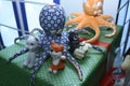 Toy octopuses tiger dog pets put on a shop counter for sale, handmade souvenirs