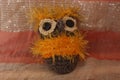 This toy owl is crocheted of yellow and brown threads. The eyes are made of buttons. Royalty Free Stock Photo